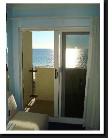 sliding door to private balcony with view of the beach